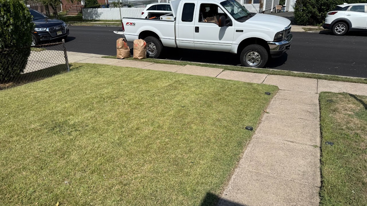 Freshly cut front lawn with service truck nearby